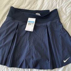 Nwt Nike Tennis Skirt In Navy. Size Medium. Has Built In Shorts With A Pocket. Nike Spring Pleated Skirt, Nike Pleated Skirt Fitted Bottoms, Navy Pleated Tennis Skirt, Nike Skirted Bottoms For Summer, Nike Lined Skirt For Spring, Navy Stretch Lined Skirt Bottoms, Nike Stretch Lined Skirt Bottoms, Nike Short Lined Skirt, Nike Summer Pleated Skirt