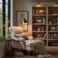 a living room filled with lots of furniture and bookshelves next to a window