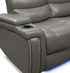 a grey reclining couch with blue lights on the armrests and head rest