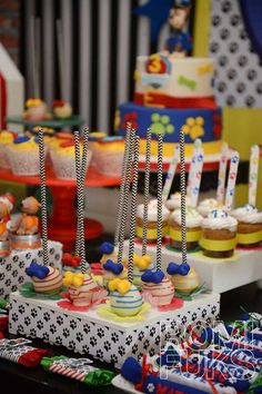 an assortment of cupcakes on display at a children's birthday party