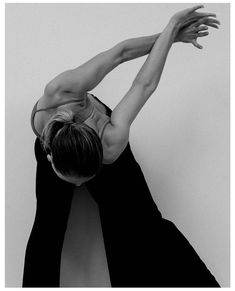 a woman in black and white doing a handstand