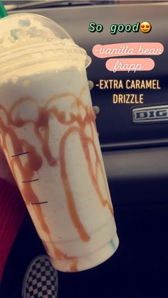 someone holding up a drink with caramel drizzle on the inside of it