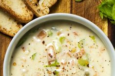 a bowl of soup with bread on the side