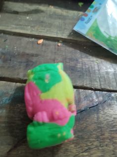 a teddy bear cake sitting on top of a wooden table next to a bag of candy