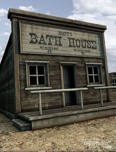 an old bath house sitting on top of a dry grass field