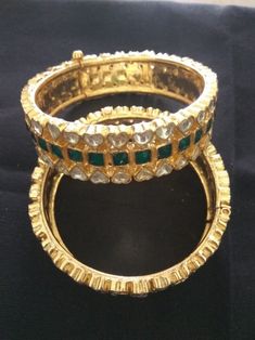 *This is Gold Finish Kundan Bangles.Its Perfect for Wedding Occasion as well as Unique and Ethnic Traditional Bangle to gift and Also Bridal wear to match with Wedding Outfits. *Its made from Silver n Copper mix material and 100% Handmade. *Its available in Various Sizes like 2,2.2,2.4,2.6 Etc Its green and white kundan combination like shown in picture. *Its open able Screwed Bangles Pair. *All Kundan stones set with silver foils handsetting method and long last guarantee of its workmanship.It Traditional Stone Work Bracelets For Festivals, Traditional Festival Bracelets With Stone Work, Heavy Kundan Bracelets For Wedding, Bollywood Kundan Wedding Bracelets, Bollywood Kundan Bracelet, Bollywood Style Kundan Bracelets For Wedding, Bollywood Style Kundan Wedding Bracelets, Round Cutdana Bracelets For Wedding, Traditional Stone Work Bracelets For Festive Occasions