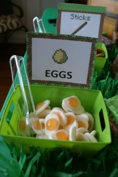 eggs are in a green bowl on the grass with stickers and tags attached to them