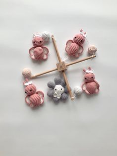 several crocheted animals sitting on top of each other in the shape of a cross