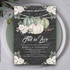 the fall in love wedding card is shown on a plate with flowers and pearls around it