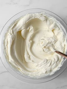 a bowl filled with whipped cream on top of a white counter