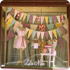 a display window with clothes and decorations in it