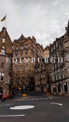 an old building with the word edinburgh over it's image in front of some buildings