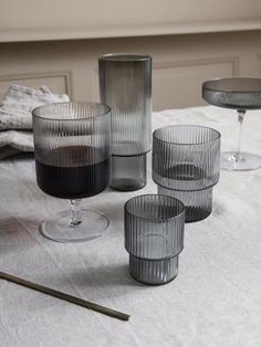 four glasses are sitting on a table