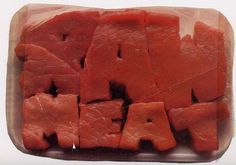 raw meat cut into small pieces and placed in a plastic container with the words raw on it