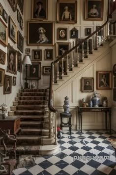 a staircase with pictures on the wall and paintings on the walls behind it in an old style home