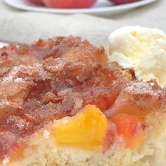 a close up of a piece of cake on a plate with fruit in the background