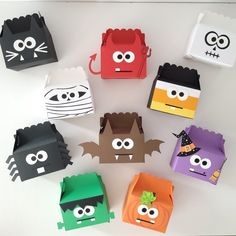 several different colored paper bags with faces on them