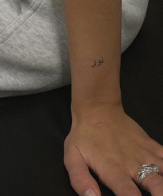 a person with a small tattoo on their wrist