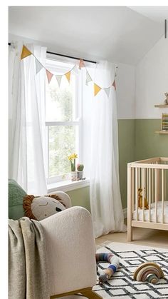 a baby's room with green walls and white curtains