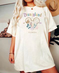 Disney Summer Shirt With Letter Print, White Disney Shirt For Summer, Summer Crew Neck Shirt For Disney Fan Events, Disney Letter Print Relaxed Fit T-shirt, Short Sleeve T-shirt With Letter Print For Disney Trips, White Tops With Letter Print For Disney Trips, White Crew Neck Top For Disney Trips, White T-shirt For Disney Trips In Summer, Disney Short Sleeve Pre-shrunk Shirt