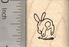 a wooden rubber stamp with a drawing of a dog on it's back side