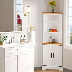 a bathroom with a sink, mirror and cabinet in it's centerpieces