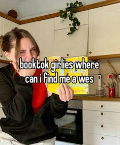 a woman holding up a book in her kitchen with the caption, boottok girls where can i find me a we