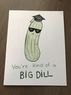 a piece of paper with a drawing of a pickle wearing a graduation cap and sunglasses