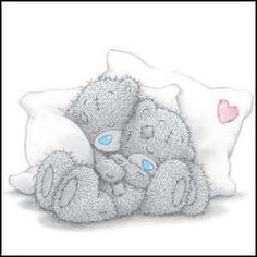 two gray teddy bears laying next to each other