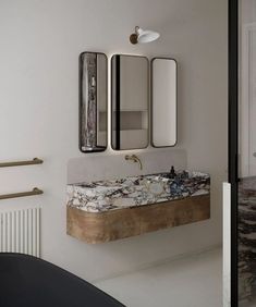 a bathroom sink with two mirrors above it