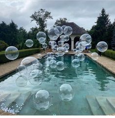 soap bubbles floating in the air over a pool