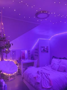 a bedroom with purple lighting and white bedding