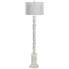 a white floor lamp with a fabric shade on the top and bottom part of it