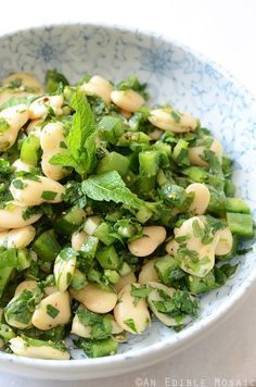 a blue and white bowl filled with pasta salad