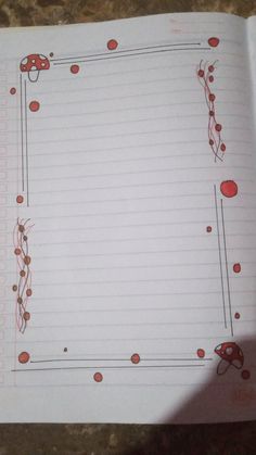 an open notebook with red and black designs on it