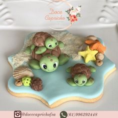 there is a cake that looks like some little turtles on the beach with shells and starfish