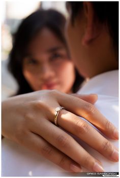 a close up of a person wearing a wedding ring