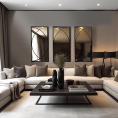 a living room with couches, tables and mirrors on the wall in front of them