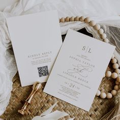 the wedding stationery is laid out on a wicker basket