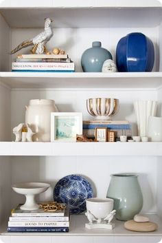 shelves with vases, books and other items on them