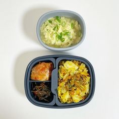 two plastic containers with food in them on a white table top next to each other