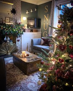 a living room filled with furniture and a christmas tree