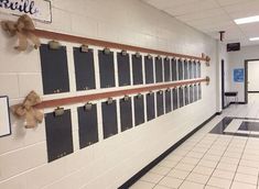 an empty hallway with several bulletin boards on the wall