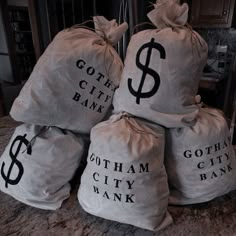 five bags filled with money sitting on top of a counter