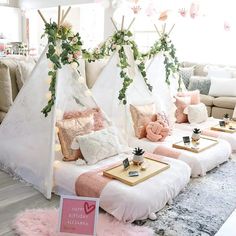 a living room filled with lots of furniture and decor on top of a wooden floor