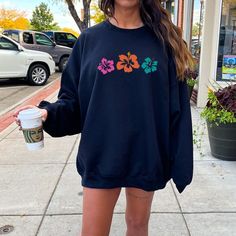 Get ready for summer in style with the Hibiscus Flower Sweatshirt, featuring an oversized, trendy Y2K vibe that perfectly combines preppy clothing with a beachy, coconut girl aesthetic. Whether you're looking for a cozy crewneck sweater or a statement piece to layer over your summer shirts, this sweatshirt is a must-have for any VSCO girl wardrobe.   *USUALLY SHIPS WITHIN 1-4 DAYS* -Gildan crewneck sweatshirt -For oversized look size up 1-2 sizes -Comfy & Cozy -Ink designs -Collar is ribbed knit Long Sleeve Sweatshirt For Summer Streetwear, Oversized Sweatshirt For Beach Vacation, Oversized Sweatshirt For Beach Season Vacation, Oversized Graphic Print Sweatshirt For Vacation, Oversized Sweatshirt For Summer Beach, Oversized Sweatshirt For Beach In Summer, Oversized Summer Sweatshirt With Graphic Print, Oversized Graphic Print Sweatshirt For Summer, Casual Summer Beach Sweatshirt