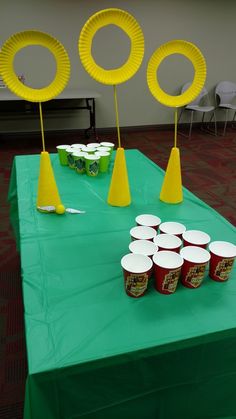 a table topped with cups and paper plates