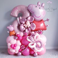 a bunch of balloons that are in the shape of peppa pig and princesses