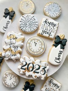 decorated cookies on a plate with new year's eve and date written on them