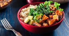 a red bowl filled with rice, vegetables and tofu next to other food items